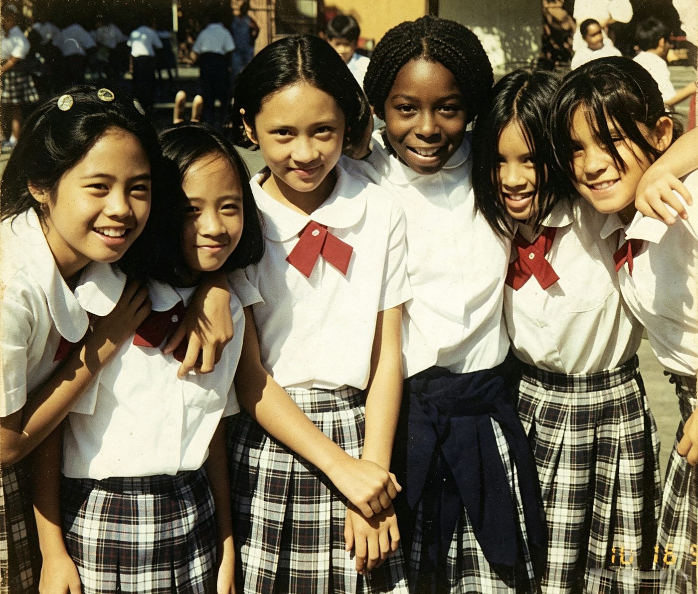 Girls in plaid uniforms smile together